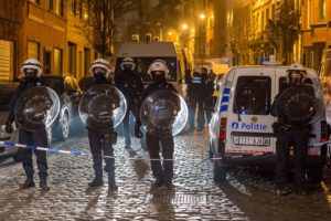 Police officers secure a street during a raid in the Molenbeek neighborhood of Brussels, Belgium, Friday March 18, 2016. After an intense four-month manhunt across Europe and beyond, police on Friday captured Salah Abdeslam, the top fugitive in the Paris attacks in the same Brussels neighborhood where he grew up. (AP Photo/Geert Vanden Wijngaert)